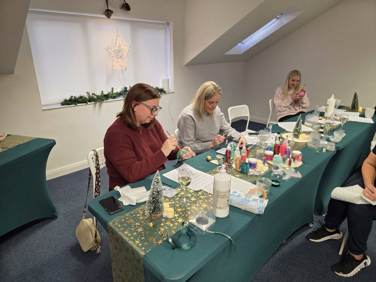 Guests decorating Christmas baubles during the Baubles and Bubbles workshop at The Collective